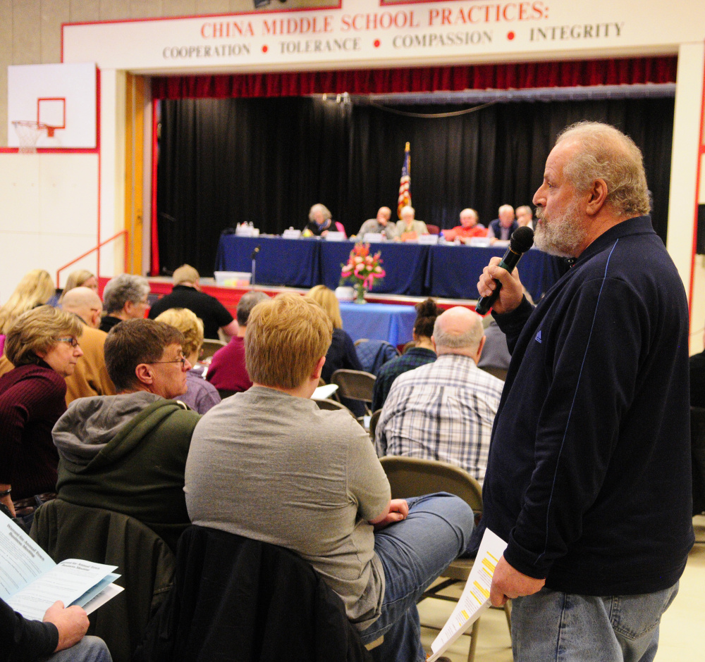 China Lake Association President Scott Pierz speaks during a debate Saturday at the China Town Meeting in the China Middle School gymnasium.