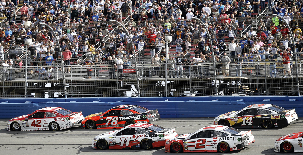 Martin Truex Jr. (78) trails eventual winner Kyle Larson (42) on the penultimate lap, as Clint Bowyer (14) and Brad Keselowski (2) pass Denny Hamlin (11) and Truex for Keselowski to finish in second place during the NASCAR race Sunday at Auto Club Speedway in Fontana, California.