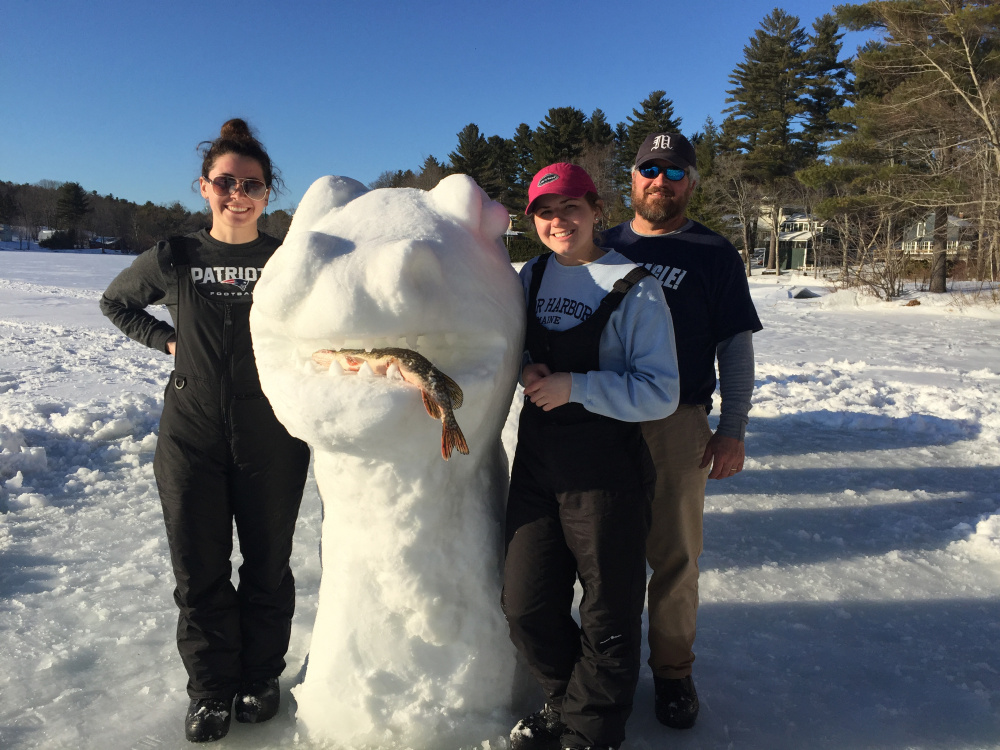 From left are Molly, Emily and Jim Russell with "The Cobbossee Lake Monster," which was 25 to 30 feet long.