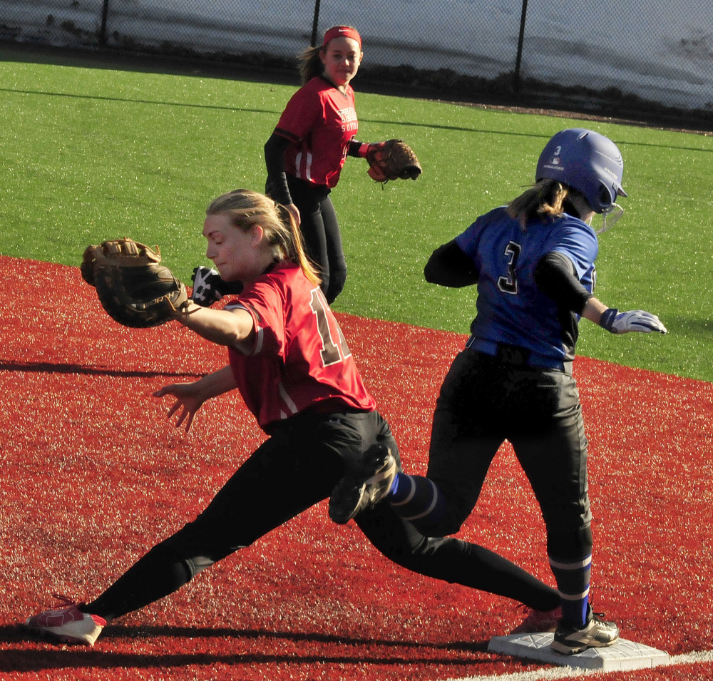 Thomas first baseman Korrie Laren makes the play as Colby's Robin Spofford runs through the bag Thursday in Waterville.