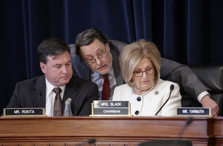 House Budget Committee Chair Diane Black, R-Tenn., right, joined at left by Rep. Todd Rokita, R-Ind., and panel staff member Jim Bates, works on the Republican health care bill, on Capitol Hill  Thursday.