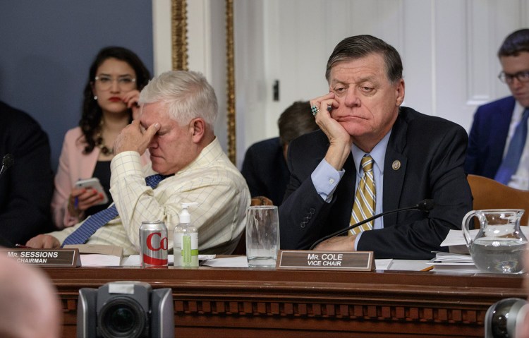 After eight hours of debate, House Rules Committee Chairman Pete Sessions, R-Texas, left, and Rep. Tom Cole, R-Okla., the vice chair, listen to arguments from committee chairs Wednesday as the panel meets to shape the final version of the Republican health care bill.