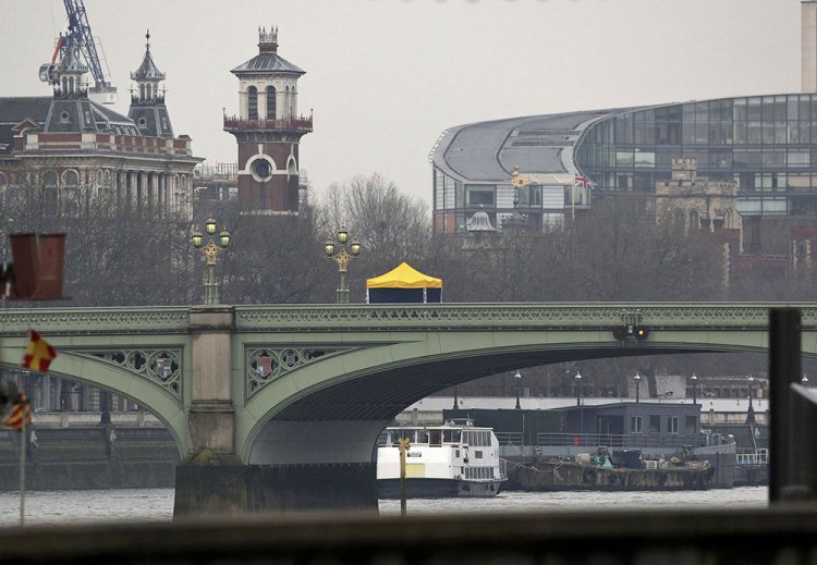 A forensics tent on Westminster Bridge is seen from Victoria Embankment in London on Thursday, a day after an attacker killed three people before being fatally shot by police inside the gates of Parliament. 
