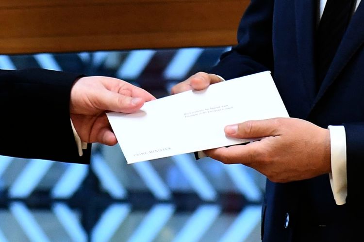 UK Permanent Representative to the EU Tim Barrow hand-delivers the letter signed by Britain’s Prime Minister Theresa May that formally triggers the beginning of Britain’s exit from the European Union. Receiving the letter, right, is EU Council President Donald Tusk.