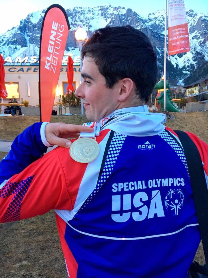 Lucas Houk shows the gold medal he won Monday in cross country skiing at the Special Olympics in Austria.