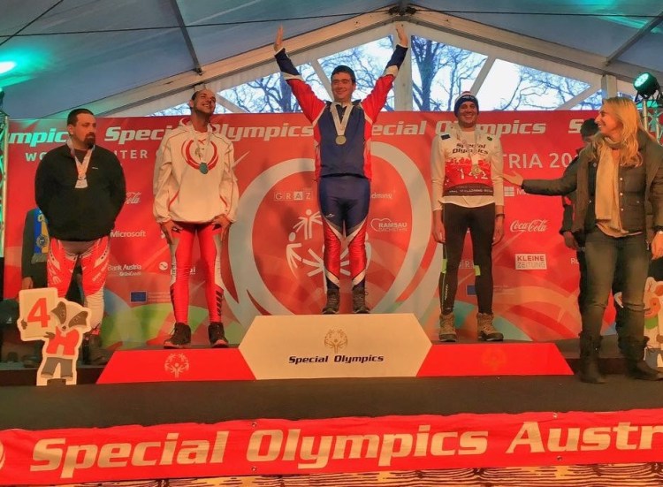 Lucas Houk is awarded the gold medal Monday for the men’s 5-kilometer freestyle race.