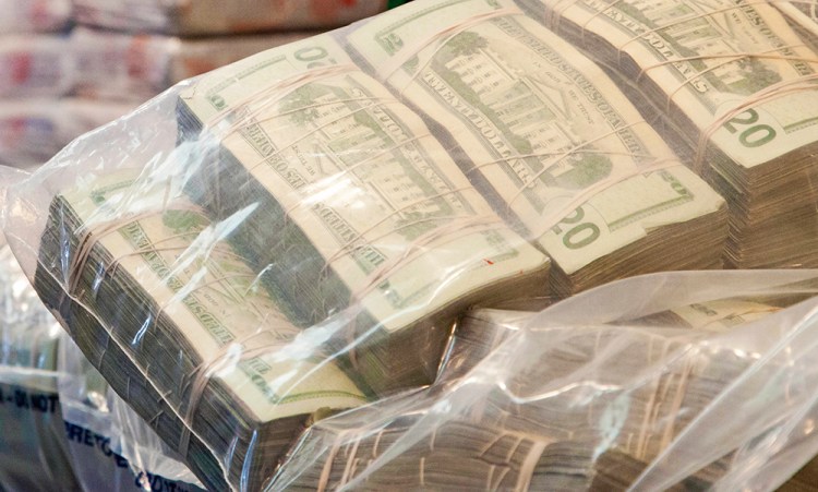While the DEA had a warrant when it seized these sacks of money during a heroin trafficking investigation, a Justice Department report says the DEA also seizes and keeps cash unrelated  to any new or ongoing criminal investigation.