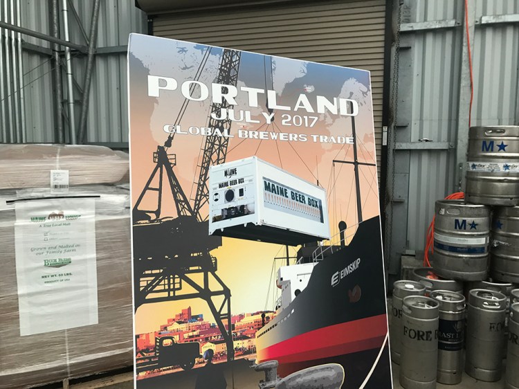 A poster on display Thursday at  Eimskip's container facility on the Portland waterfront shows an artist's conception of the "Maine Beer Box" that will be shipped to Iceland for a June festival.