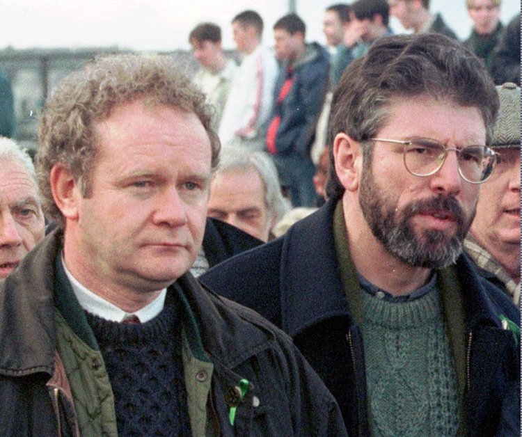 Martin McGuinness, left, then-Sinn Fein chief negotiator, and Gerry Adams, Sinn Fein's president, participate in the Bloody Sunday anniversary march in Londonderry, Northern Ireland, on Feb. 1, 1998.  