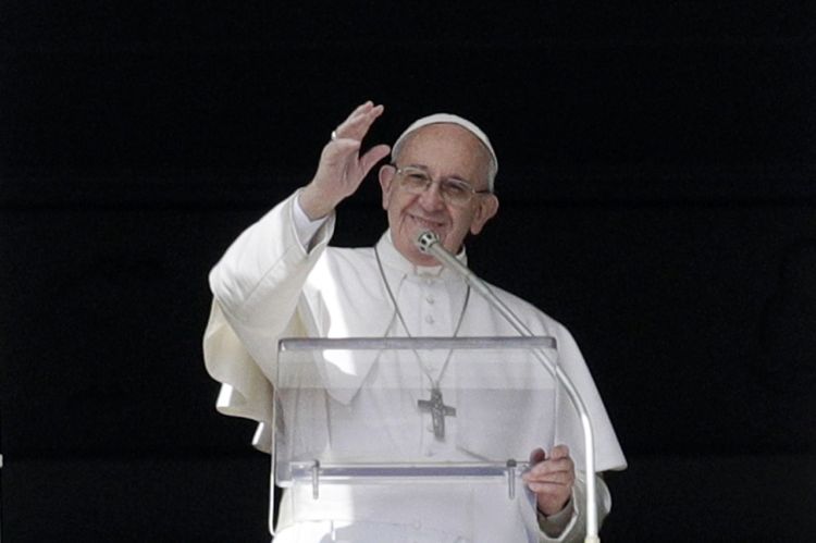 Pope Francis waves to faithful after delivering the Angelus prayer  in St. Peter's Square at the Vatican on Sunday.