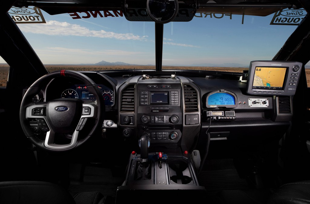 The interior of the Ford F-150 Raptor race truck features a custom-fabricated roll cage, MasterCraft seats with five-point harness safety belts, Lowrance GPS, RacePak digital dash and a data logger to track vehicle performance.  