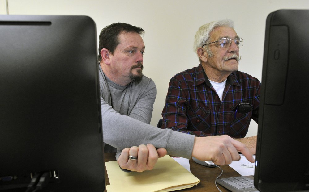 John Kiley and his father, Bill Kiley, both of New Gloucester, at an adult computer literacy class March 22 at the Gray-New Gloucester Adult & Community Education center. The elder Kiley, 80, was completing his third week of the five-week course. Staff photo by Shawn Patrick Ouellette