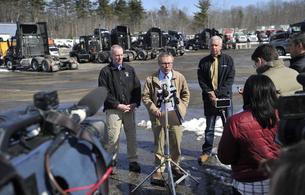From left, Sgt. Ken Grimes of the State Fire Marshal's Office, Maine Department of Public Safety spokesman Steve McCausland and Kelly Moore of R.C. Moore speak with the press Monday at the trucking company's facility in Poland. (Staff photo by Shawn Patrick Ouellette/Staff Photographer)