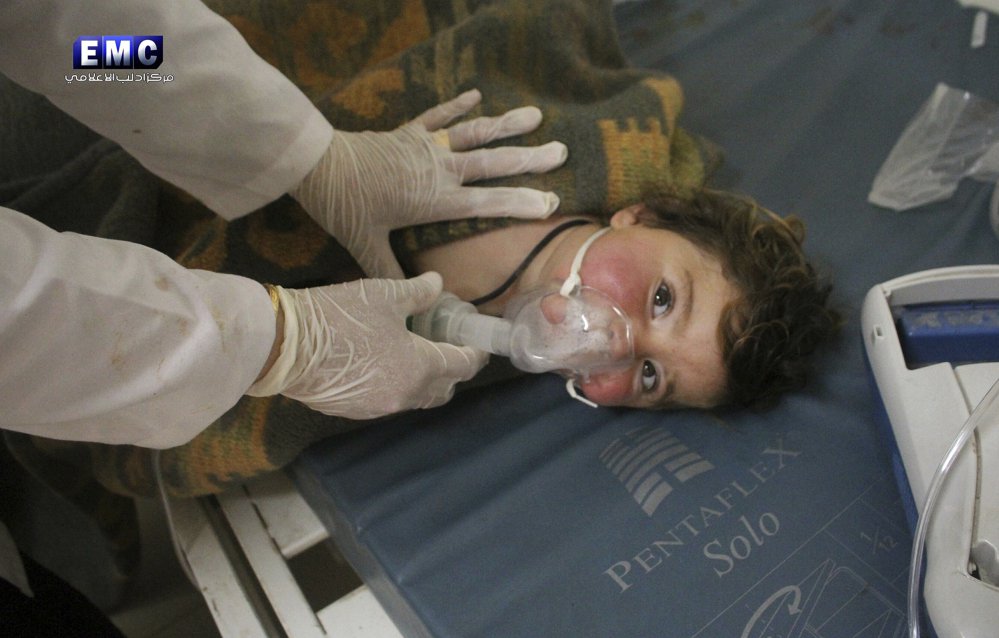 In a photo provided Tuesday by the Syrian anti-government activist group Edlib Media Center, a Syrian doctor treats a child in Khan Sheikhoun, Syria.