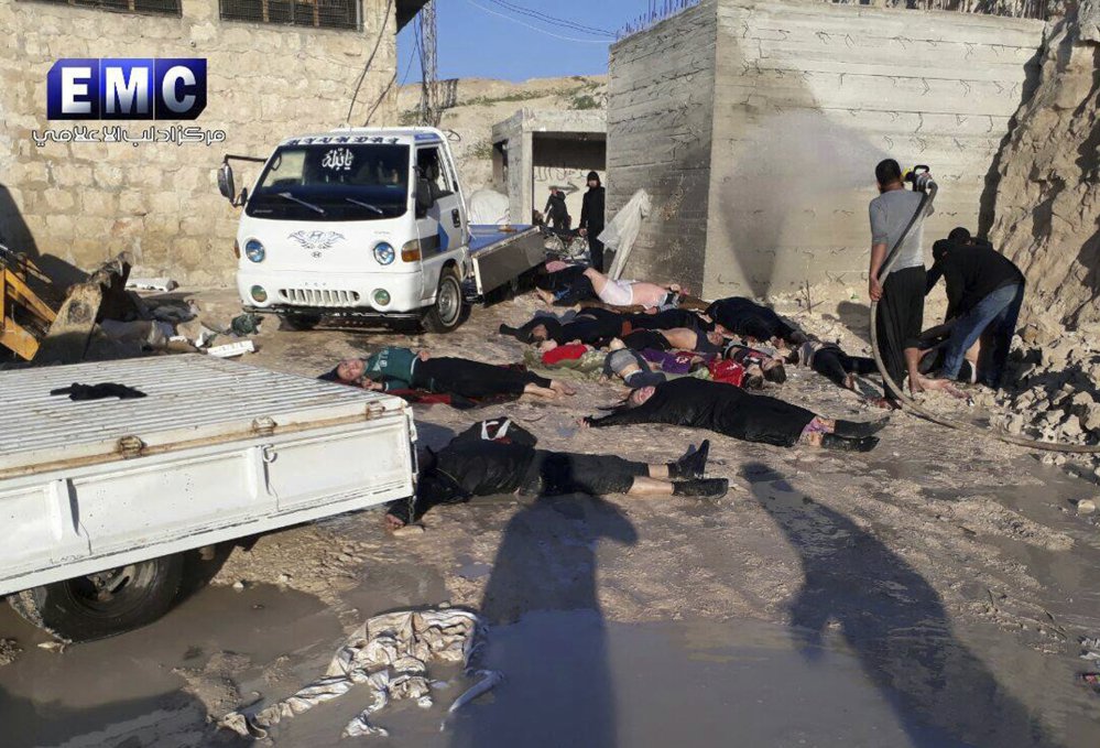 Crews retrieve victims of a suspected chemical attack in the town of Khan Sheikhoun, northern Idlib province, Syria, in this April 4 photo. A senior U.S. official says the United States has concluded that Russia knew in advance of the attack.