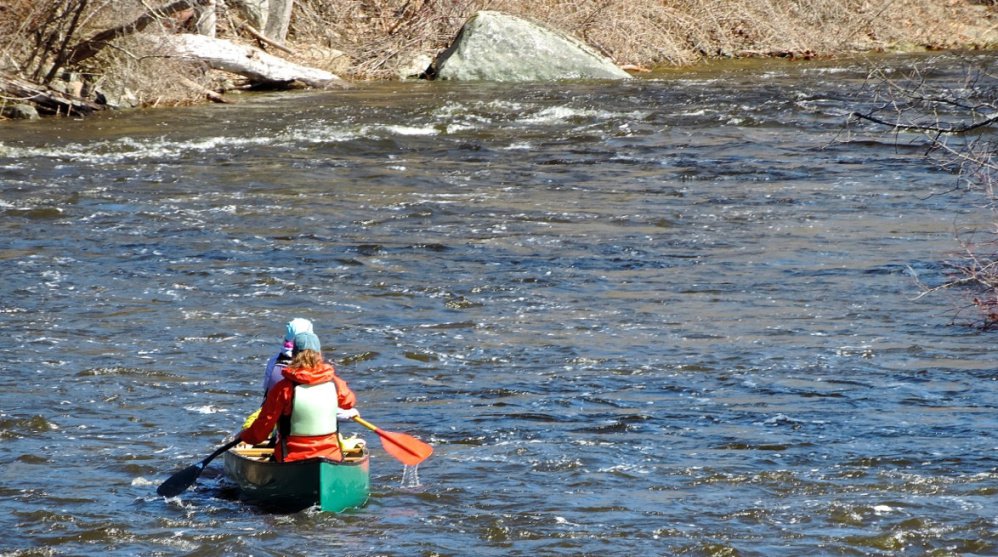 A duo celebrates the outdoors with a paddle on the whitewater below the Head Tide Dam.