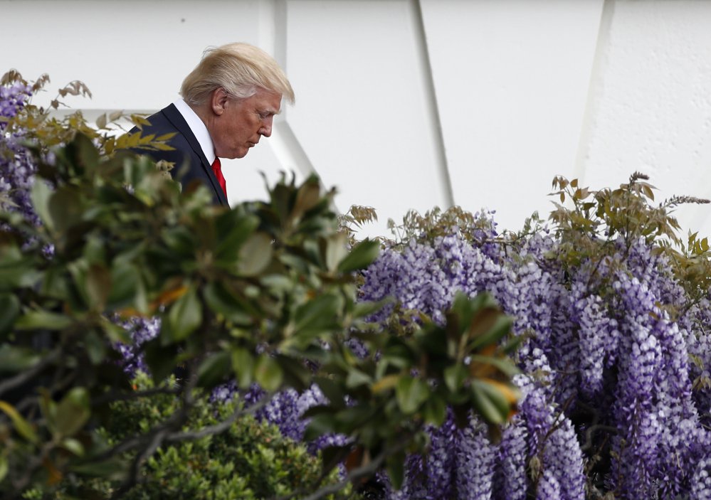 President Trump walks down the stairs from the Truman Balcony to the South Lawn during the annual White House Easter Egg Roll in Washington on Monday.