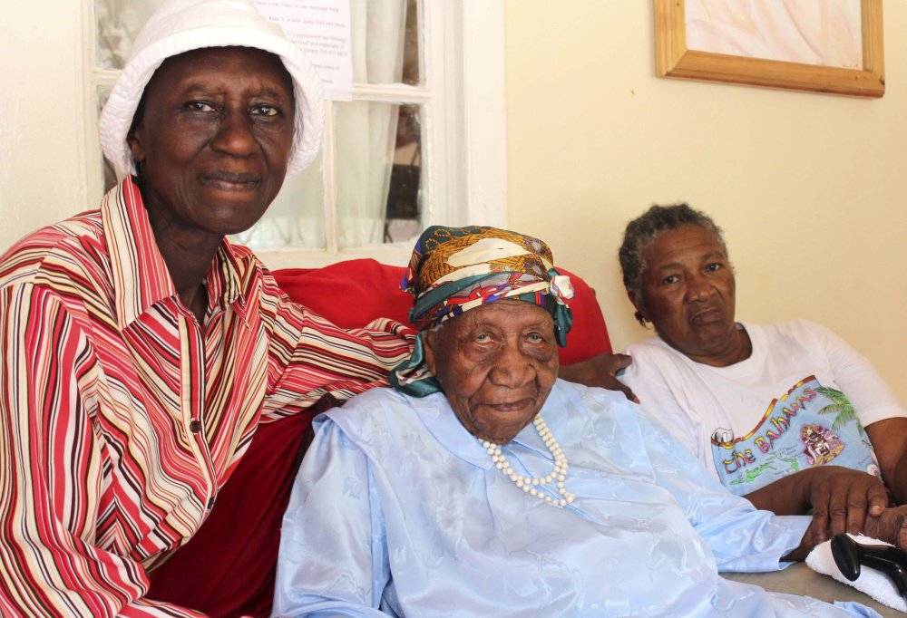 Violet Brown, center, poses with her caregivers in Jamaica on Sunday. Brown was a Jamaican who was the oldest verified living person in the world until her death at the age of 117 years, 189 days on September 15, 2017. She credits her longevity to hard work and faith. Associated Press/Raymond Simpson.