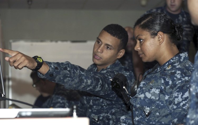 Petty Officer 3rd Class DonPaul Mitchell, left, assigned to the guided-missile submarine USS Georgia, instructs Ensign Tabitha Strobel, Georgia's main propulsion assistant, in a trainer at Naval Submarine Base Kings Bay in Georgia in 2012. With women now serving on submarines, future subs are being built to specifically accommodate gender differences including height, reach and strength.