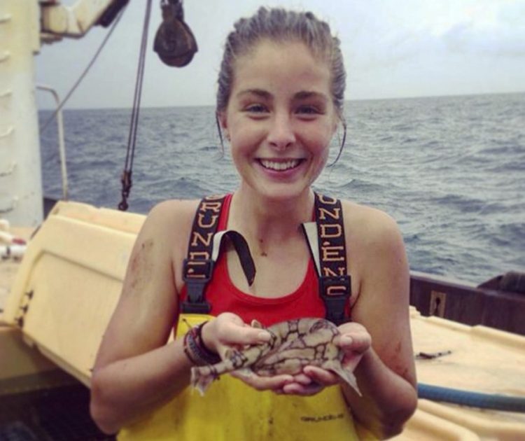 Hanna Sihler, an oceanography and biophysics major at the University of New England, holds a chain dogfish.