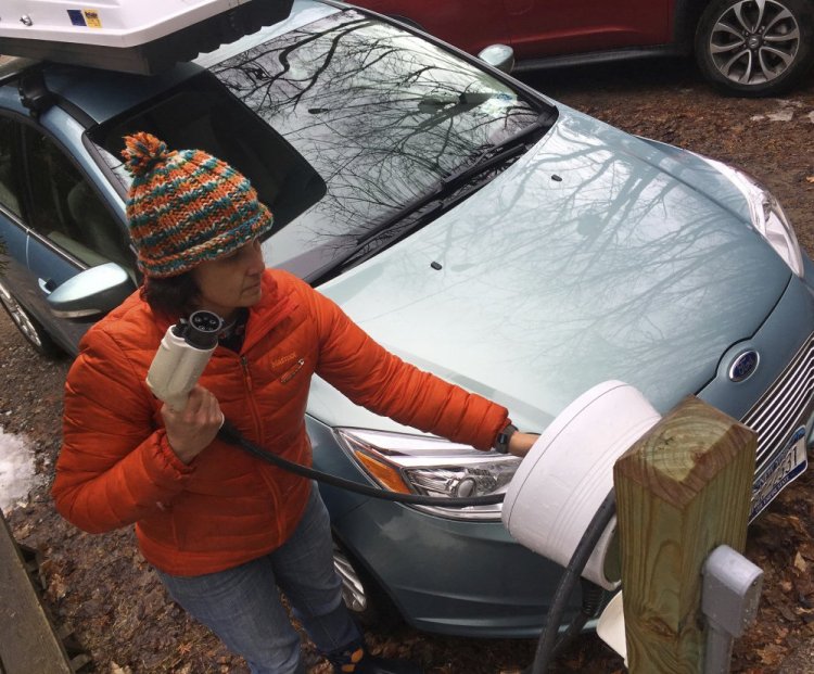 Sunita Halasz shows how she charges her electric car at her home in Saranac Lake, N.Y. Halasz has tips for "driving electric" along lonely New York Adirondack Mountains roads.