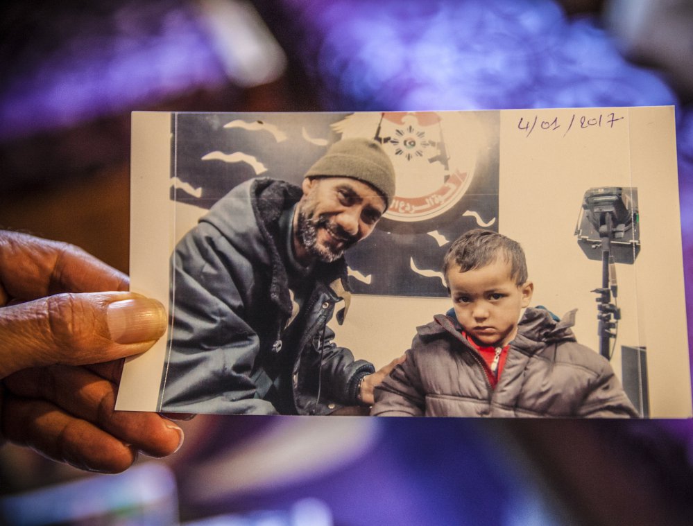 Faouzi Trabelsi shows a photo of himself with his grandson, Tamim Jaboudi, who has been trapped in a prison in Libya. Trabelsi has been unable to secure his grandson's release.