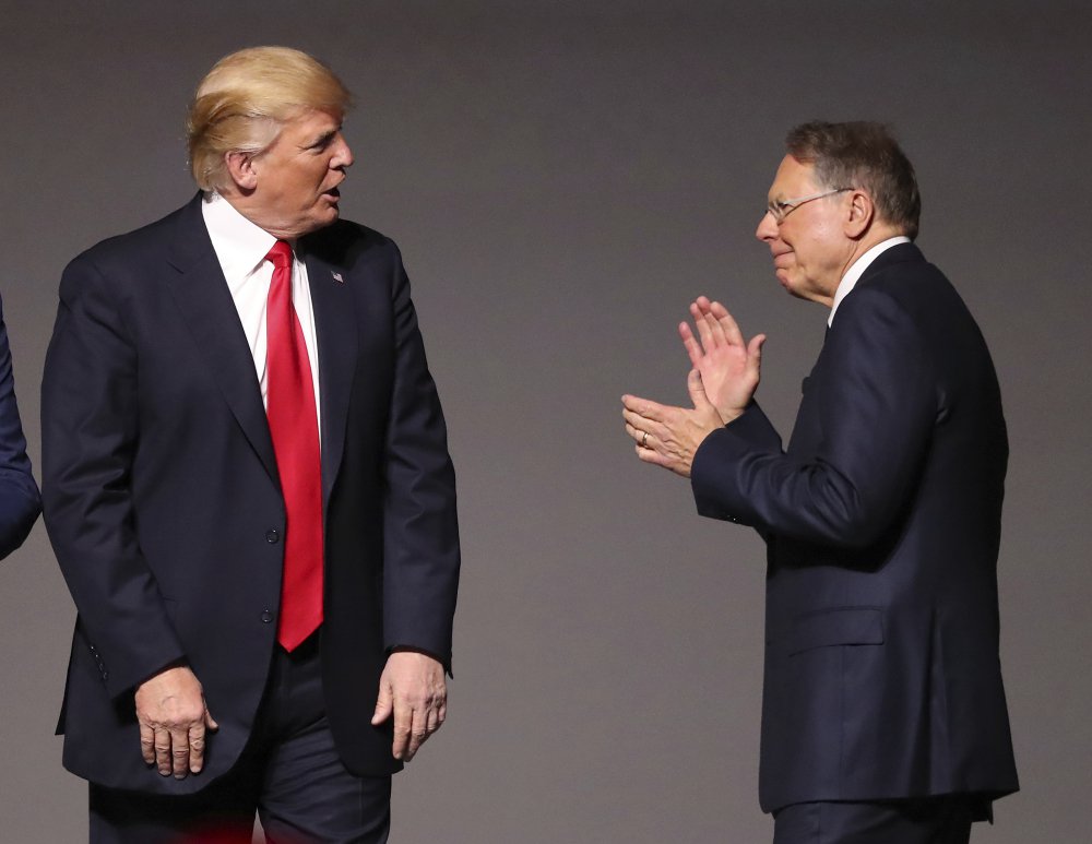 President Donald Trump, left, stands with National Rifle Association Executive Vice President Wayne LaPierre, right, as he arrives for the National Rifle Association Leadership Forum, Friday, April 28, 2017, in Atlanta. (Curtis Compton/Atlanta Journal-Constitution via AP)