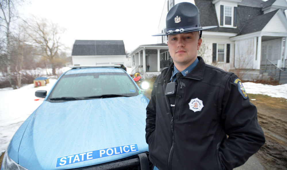 Trooper Tyler Maloon stands in front of his police cruiser Saturday at his home in Pittsfield. After Maloon responded to a report of a car-versus-deer accident early Saturday morning in Fairfield, he found that the car's occupants of the car were carrying prestigious cargo — the Vince Lombardi Trophy. The couple in the car had been taking it to the Cross Insurance Center in Bangor for viewing.