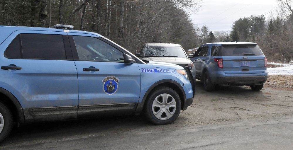 Maine State Police cruisers stand parked at the end of a driveway along South Horseback Road in Burnham while police investigate the death of Joyce Wood early Sunday morning in a house on that road.