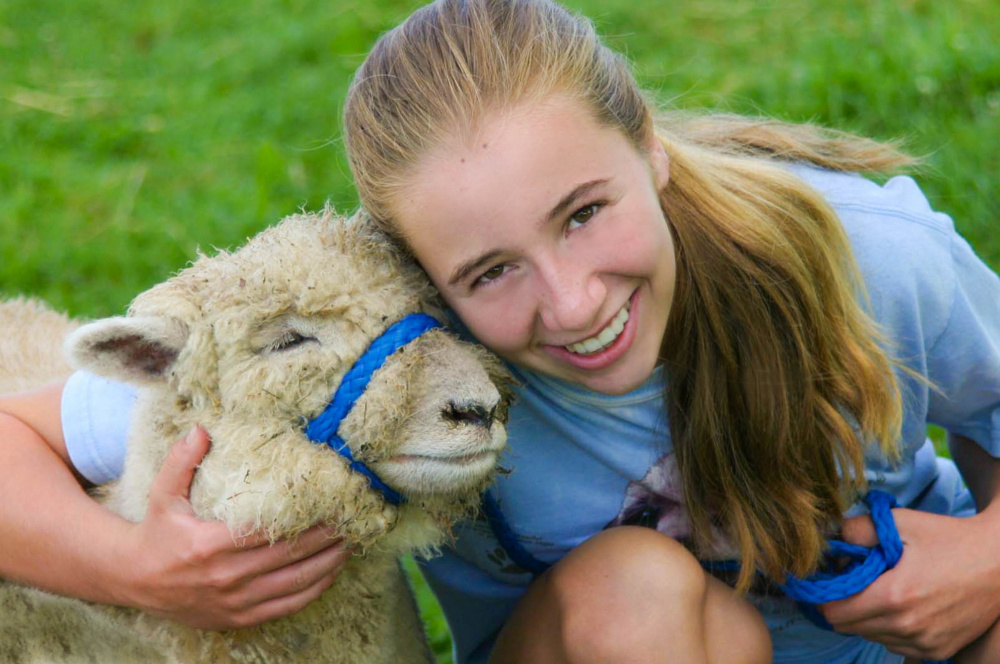 Cassidy Charette with her "adopted" sheep Erwin at Hart-to-Hart Farm Camp in 2012. The Albion Farm will host its first ShineOnCass Easter Egg Hunt Sunday, April 9. Families are asked to bring pet items to be donated to the Waterville Area Humane Society in Charette's honor.