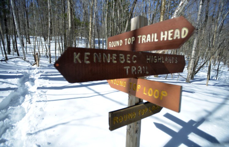 Trail signage marks the beginning of the Round Top Mountain trail in Rome on March 17, a day after game wardens found the body of Brian Peters on the mountain trail. Officials initially thought he had died of cold weather exposure, but the medical examiner says he died because of a sudden cardiac arrest.