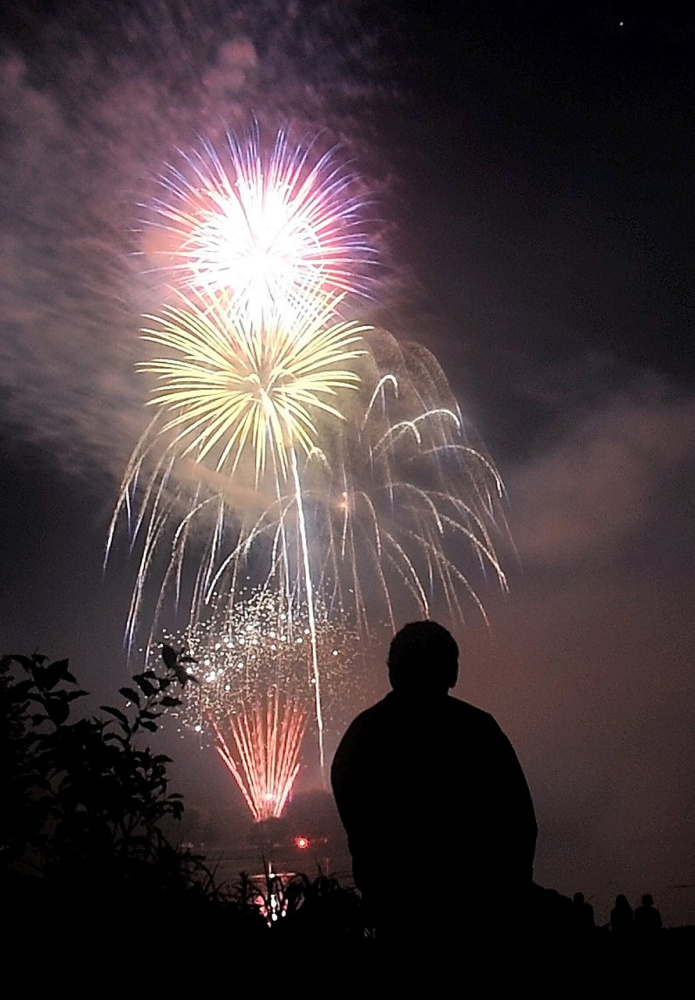 Mark Trial watches the fireworks light up the sky over the Kennebec River on July 4, 2016, during the Winslow Family 4th of July Celebration in Winslow.