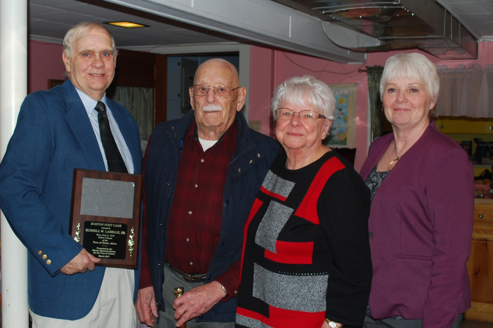 Clinton Historical Society recently presented Russell Labelle, 97, of Clinton, with the town's Boston Post Cane. From left are Clinton Historical Society President Buddy Frost, Russell Labelle Sr. with his wife Hannah Labelle, and Clinton Town Manager Pam Violette.