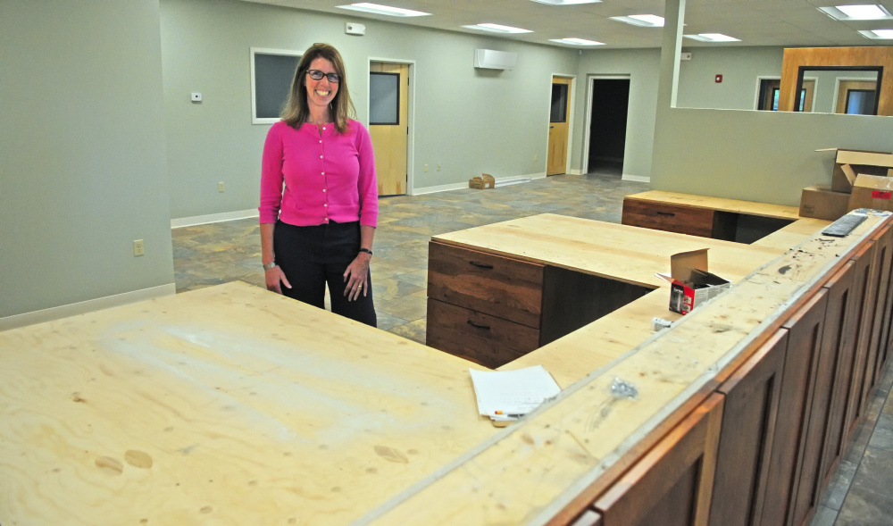 Belgrade Town Manager Carrie Castonguay, who announced Tuesday she is leaving to take another job, stands by the front counter June 8, 2016, in the new Town Office in Belgrade.