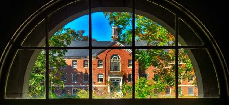 The Stevens Building is framed in a window of the Central Building during a tour on Oct. 7, 2016, at Stevens Commons in Hallowell.