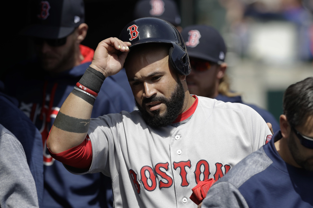 Boston's Sandy Leon enters the dugout after scoring from third on a single by Marco Hernandez during the second inning against the Detroit Tigers on Sunday in Detroit. Leon also had the game-winning hit in the eighth inning.