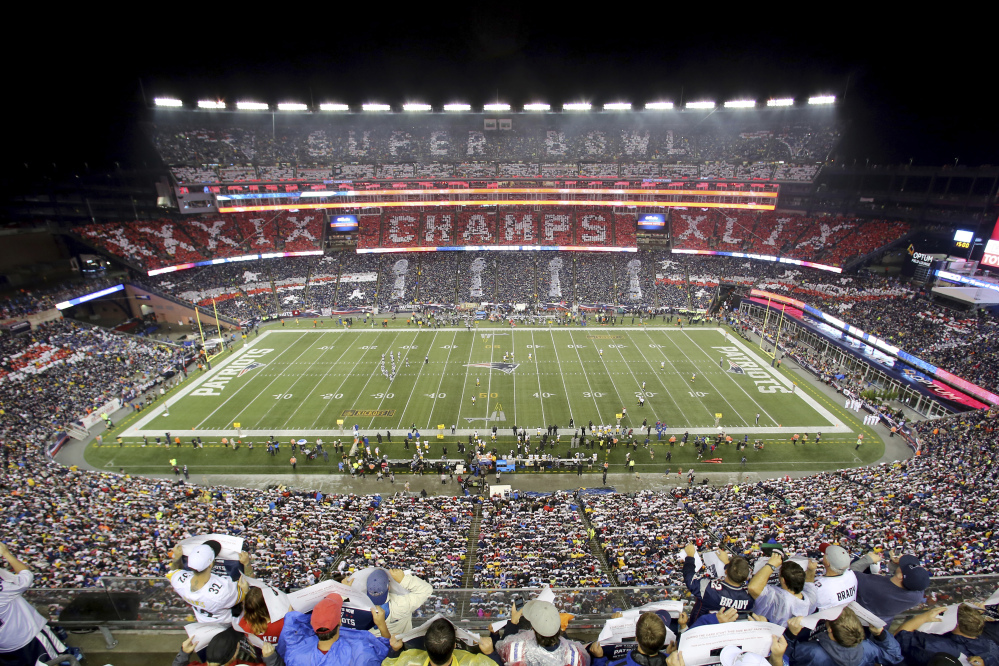 In this  Sept. 10, 2015, file photo, Patriots fans perform a card stunt commemorating their Super Bowl win before a game against the Steelers, at Gillette Stadium in Foxborough, Massachusetts. 2026 World Cup soccer games could be played in a number of modern stadiums across North America, including Gillette Stadium.