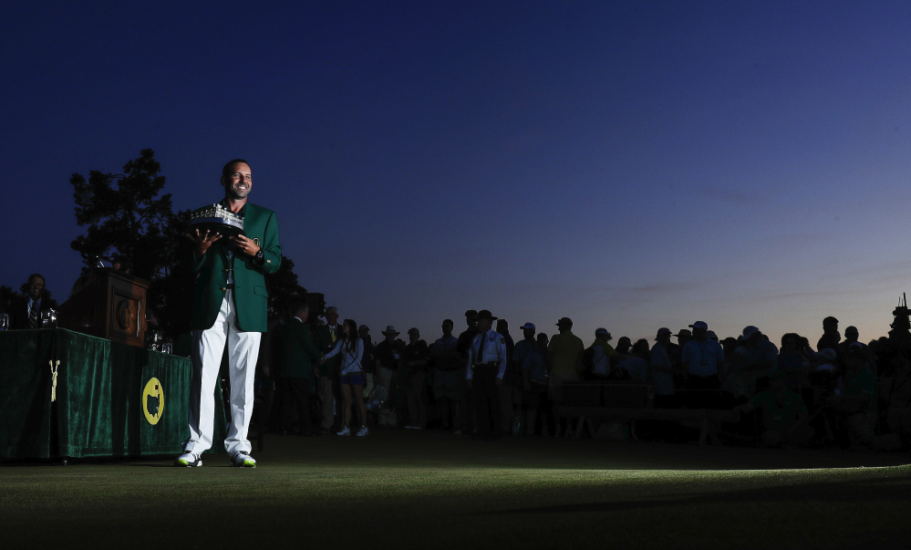 Sergio Garcia holds up his winning trophy at the green jacket ceremony after the Masters on Sunday.