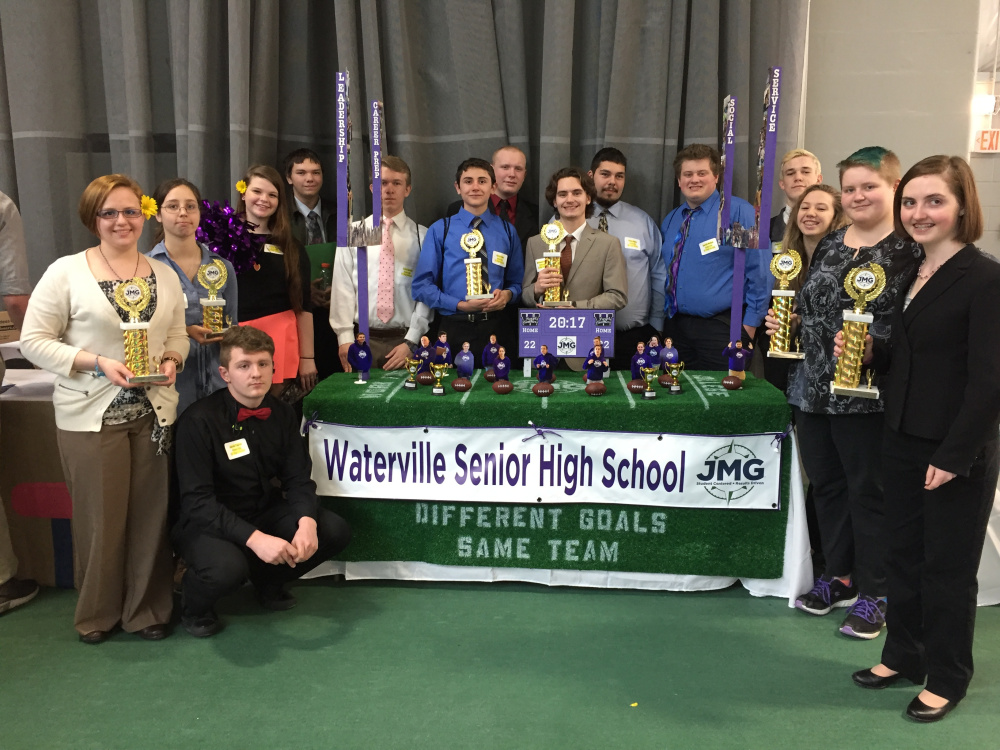Waterville Senior High School stand in front of their trophies at the Jobs for Maine's Graduates' Career Development Conference. From left are Rose Vought, Jacob Taylor (kneeling), Julia Schutz, Tasha Kavis, Nate Morgan, Cody Quirion, Kory Drake, Donnavon Doughty, Nicareece Hunter, Sulley Menz, Gareth Belton, Jackson Aldrich, Sage Hafenecker, Makalah McIntire and Alissah Paquette.