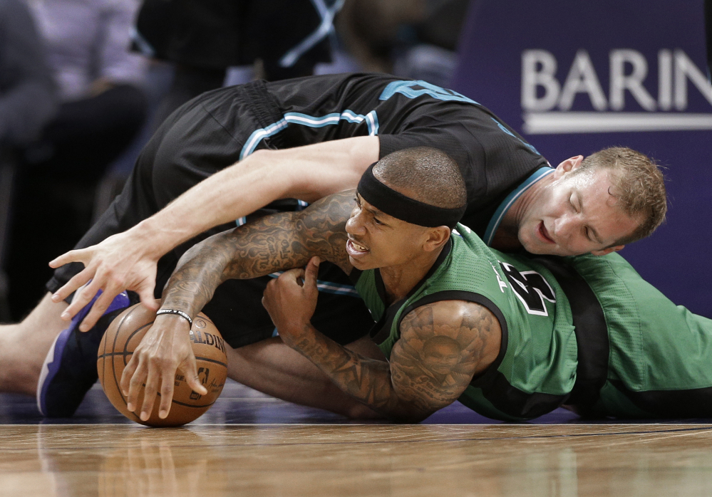 Charlotte Hornets forward Cody Zeller, top, and Boston Celtics guard Isaiah Thomas vie for a loose ball in the second half of a game in Charlotte, North Carolina last Saturday.