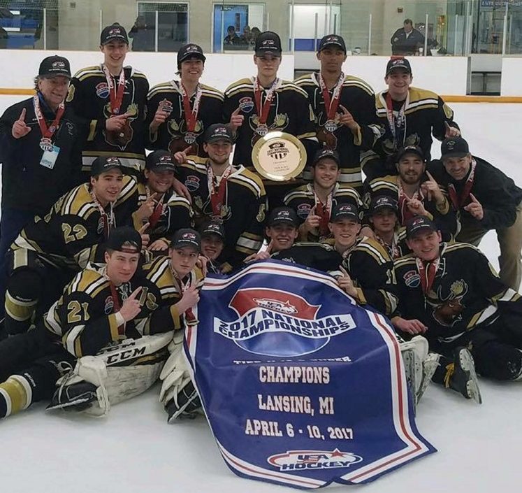 The Maine Moose 18U team celebrates after winning the Tier II 2A junior hockey national championship Monday in East Lansing, Michigan.
