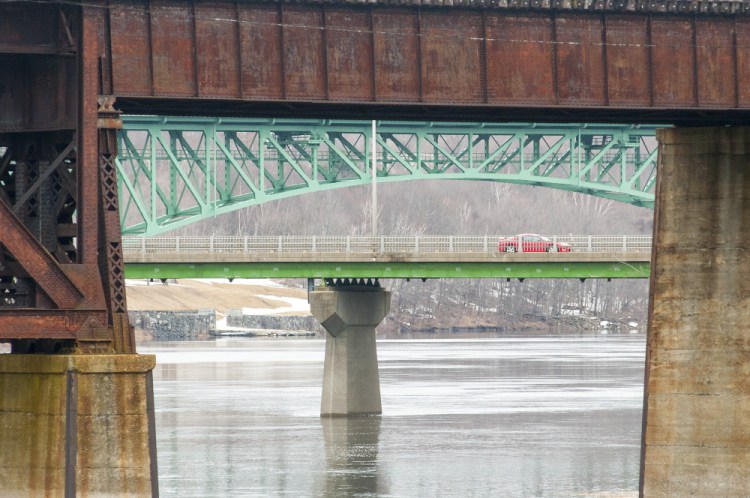 Two bridges over the Kennebec River frame a car going over the Calumet Bridge last week at Old Fort Western in Augusta. Forecasters say minor flooding is expected in Augusta and other areas on Wednesday.