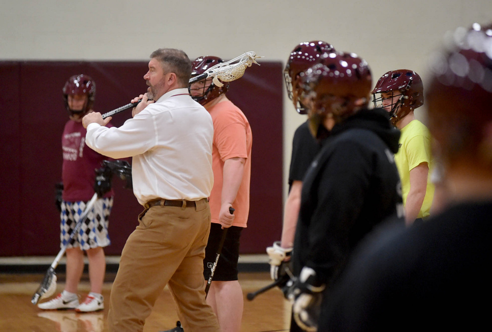 MCI/Nokomis head coach Chris Hopkins works with his players during practice Tuesday at Maine Central Institute in Pittsfield.