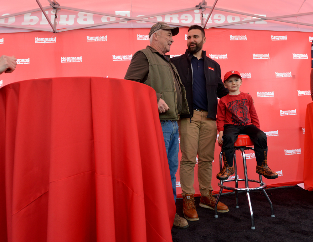 Rob Ninkovich, of the New England Patriots, stands with fans for a photograph Wednesday at Hammond Lumber Co. in Belgrade during a meet and greet.