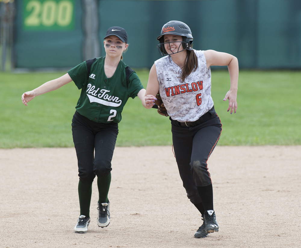 Winslow baserunner Kylee Morrissette is tagged out by Old Town's Olivia Westure during a run-down in the 6th inning of the Class B North title game last season in Brewer.