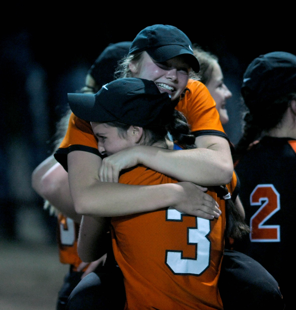 A North champs: Members of the Skowhegan softball team celebrate after they defeated Edward Little 8-2 in the Class A North title game last season in Augusta.