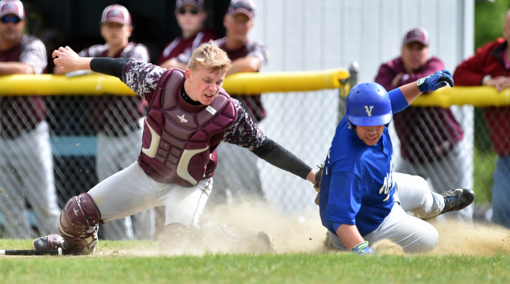 Richmond catcher Brendan Emmons tries unsuccessfully to tag out Valley runner Brandon Thomas during a Class D South semifinal last season. Emmons and the Bobcats return a talented team that should contend for a conference crown again.