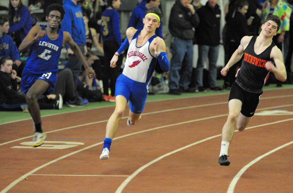 Lewiston's Abdirashid Abukar, left, Messalonskee's Tanner Burton, center, and Brunswick's Seth White head for the finish line during the 200-meter sprint at the Kennebec Valley Athletic Conference indoor track and field championships this season at Bowdoin College in Brunswick.