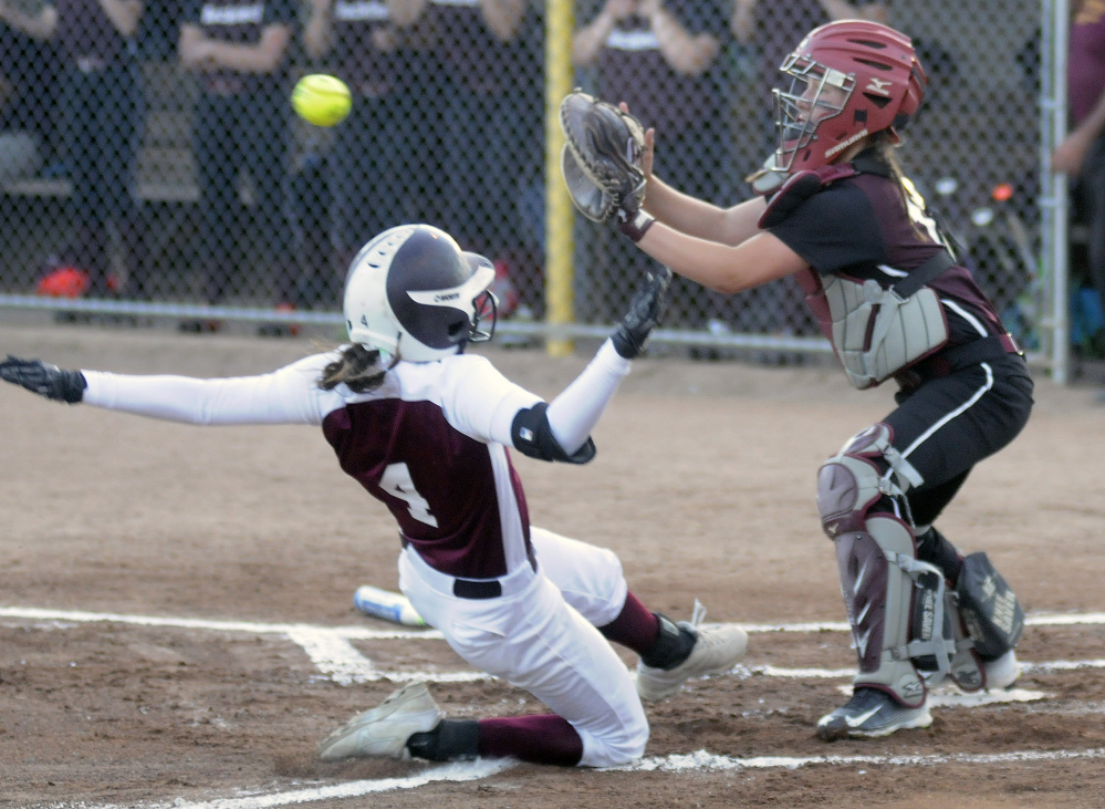 Richmond runner Meranda Martin slides safely into home under as Buckfield catcher Hannah Shields awaits the throw during the Class D South title game last season at St. Joseph's College in Standish.