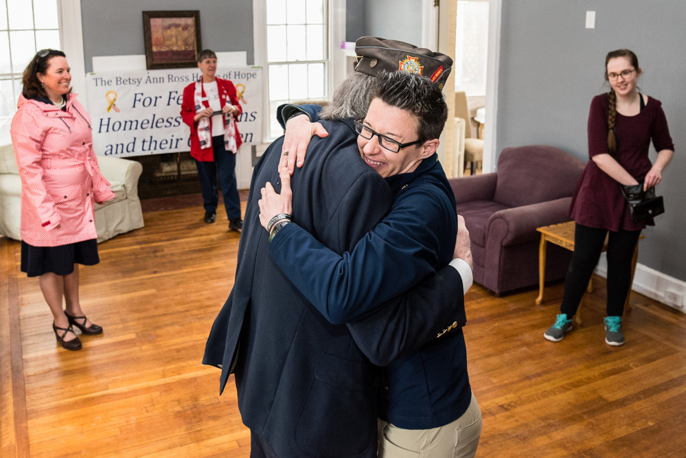 Alley Smith, regional manager of Veterans, Inc., in Lewiston, hugs Charles McGillicuddy, a Vietnam War veteran and board member of the Betsy Ann Ross House of Hope in Augusta on Thursday at a ribbon cutting and open house. The three-story building at 8 Summer St. will house eight homeless female veterans once it is complete.